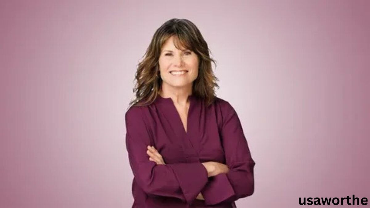 Janet Elway smiling with folded arms in a professional portrait, showcasing confidence and leadership associated with Janet Elway.