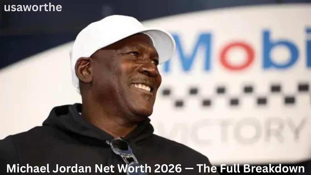 Michael Jordan smiling while wearing a white cap and black hoodie, representing his estimated $4.3 billion net worth in 2026 from Jordan Brand, endorsements, investments, and business ventures.
