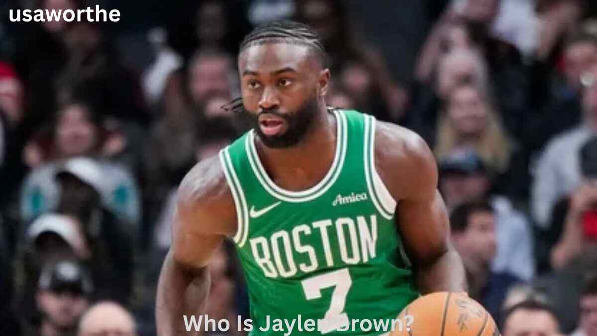 Jaylen Brown dribbles the basketball in a Boston Celtics jersey during an NBA game, highlighting his professional career and Jaylen Brown Net Worth 2026.